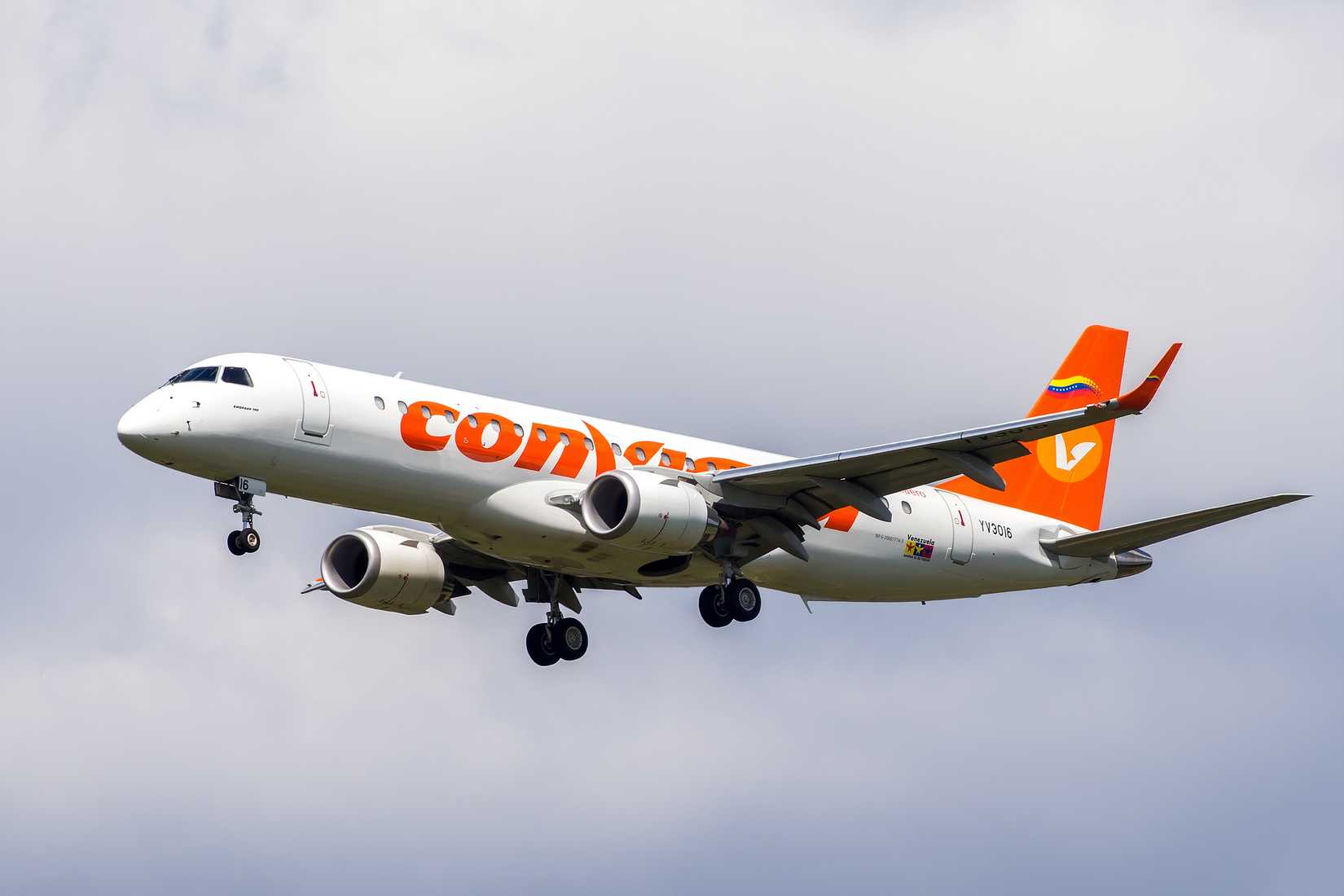 A Conviasa Embraer E190 aircraft flying in the sky.