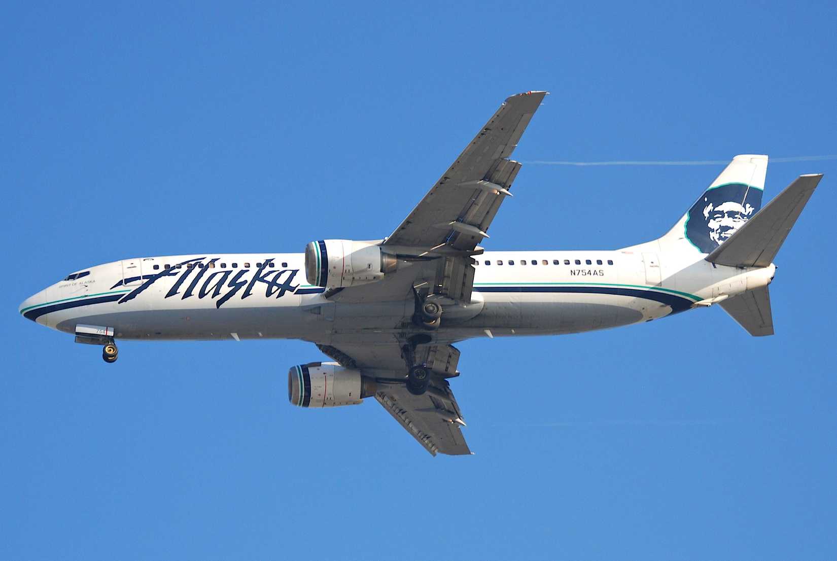 An Alaska Airlines Boeing 737-400 Flying In The Sky.