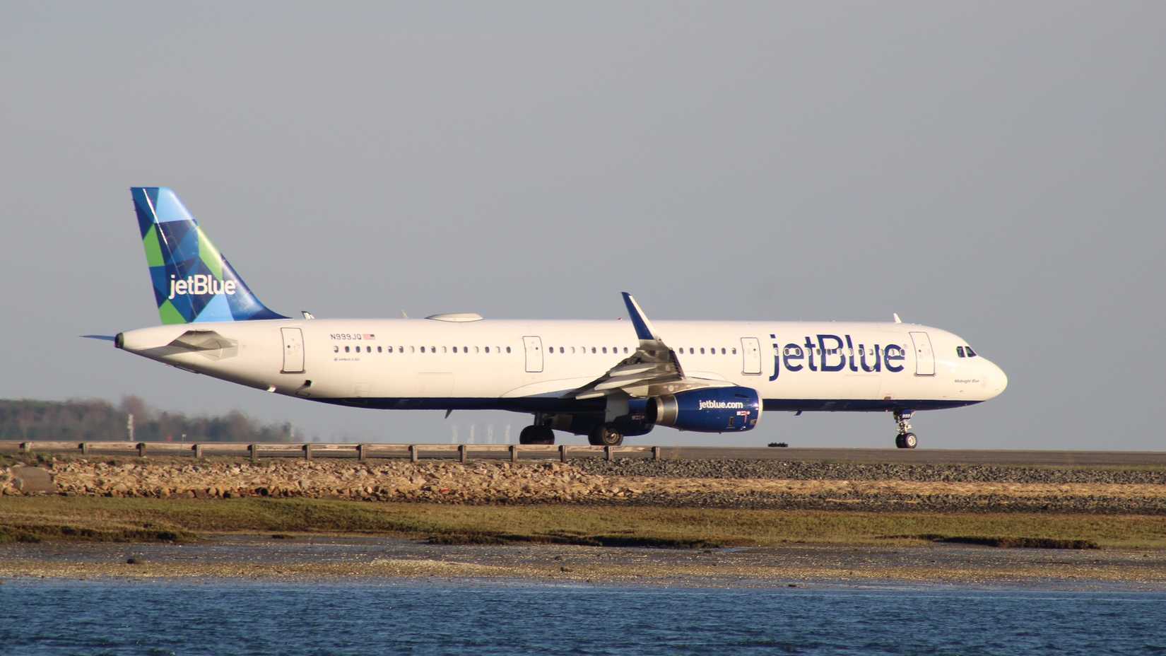 A JetBlue Airbus A321 on the apron at Boston Logan International Airport.