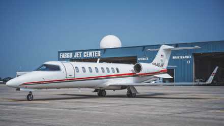 A Learjet 75 on an airport apron.