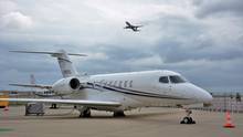 A Cessna 700 Citation Longitude parked on an airport apron.