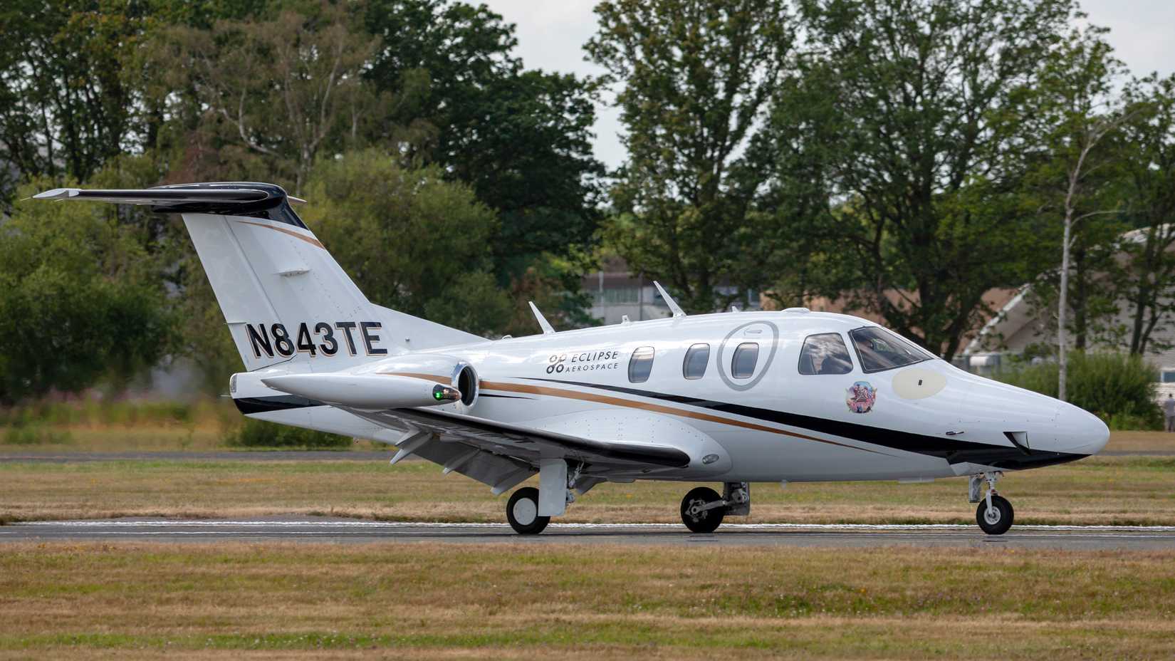 An Eclipse 500 business jet on an airport apron.