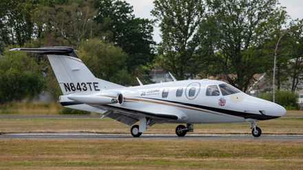 An Eclipse 500 business jet on an airport apron.