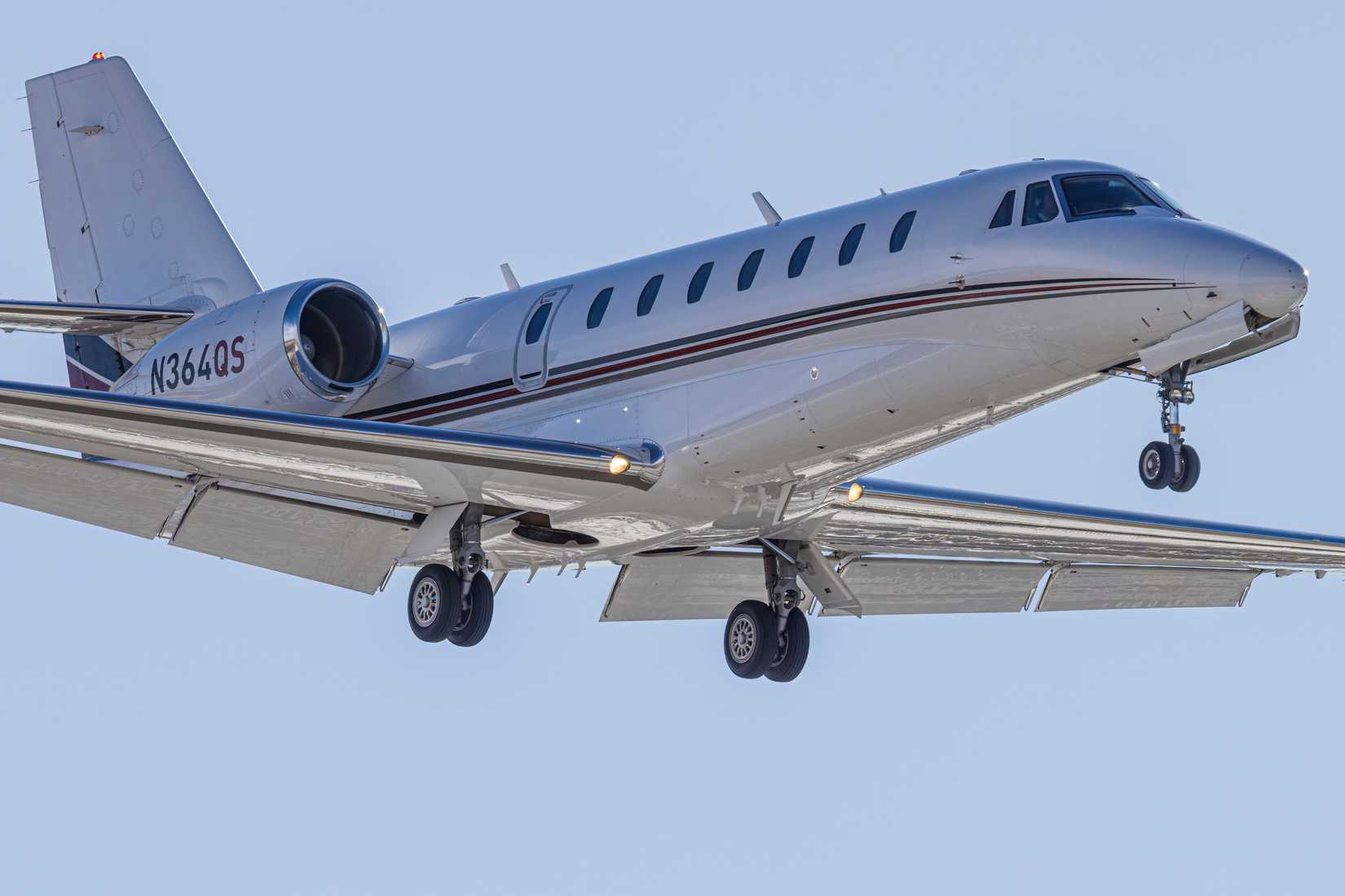 A Closeup of a Cessna Citation Excel XLS flying in the sky.