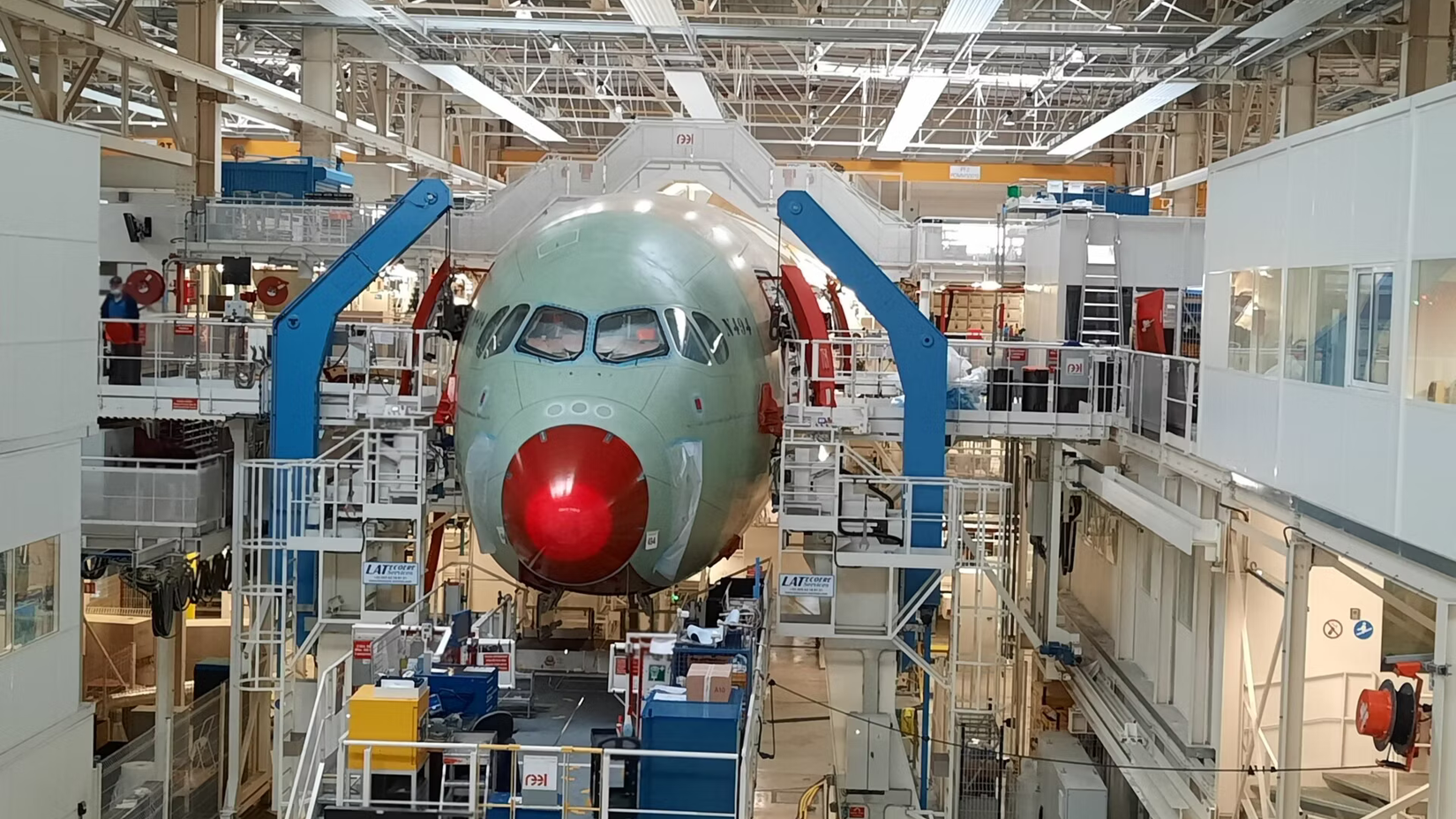 An Airbus A350 being assembled in a factory.
