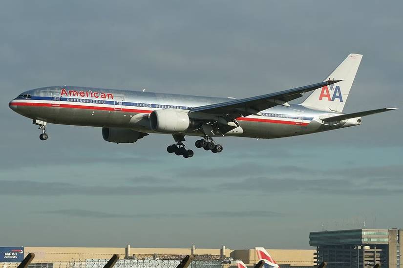 An American Airlines Boeing 777 flying in the sky.