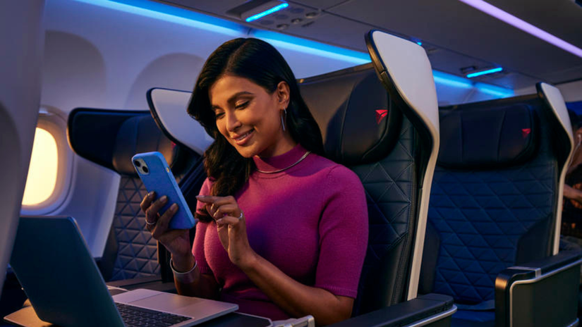 A Passenger sitting in a Delta First Class domestic seat.