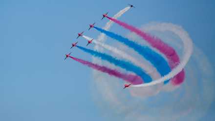 The Red Arrows Showcasing A Spiral Smoke Maneuver.