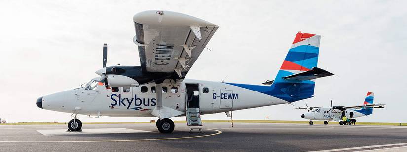 An Isles of Scilly Skybus Twin Otter parked on an airport apron.