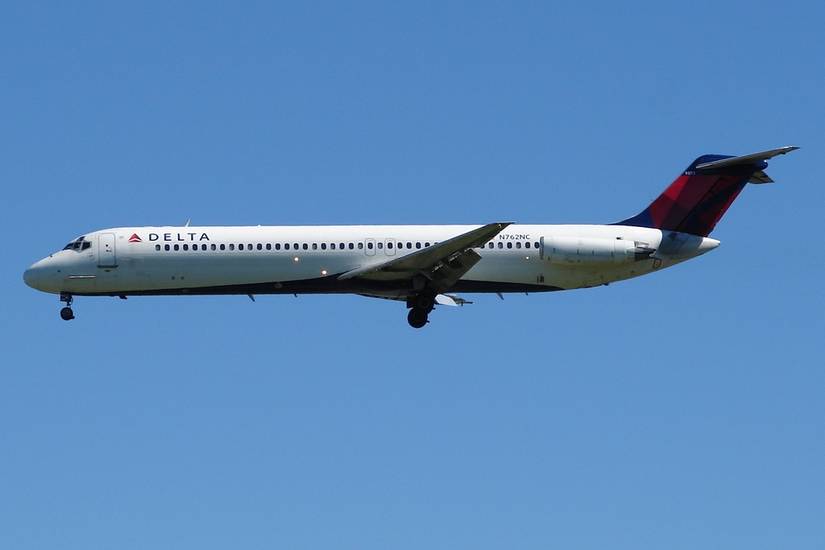 A Delta Air Lines DC-9-50 flying in the sky.