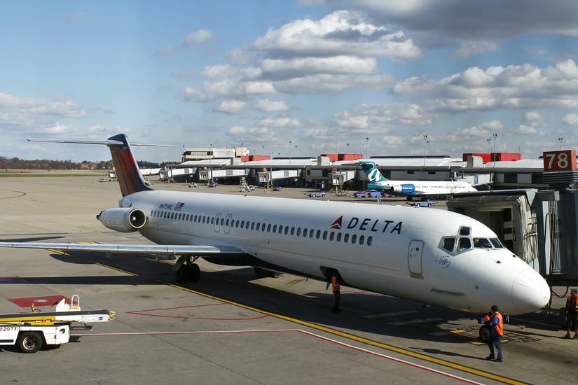 A Delta Air Lines DC-9-50 parked at a gate on an airport apron.