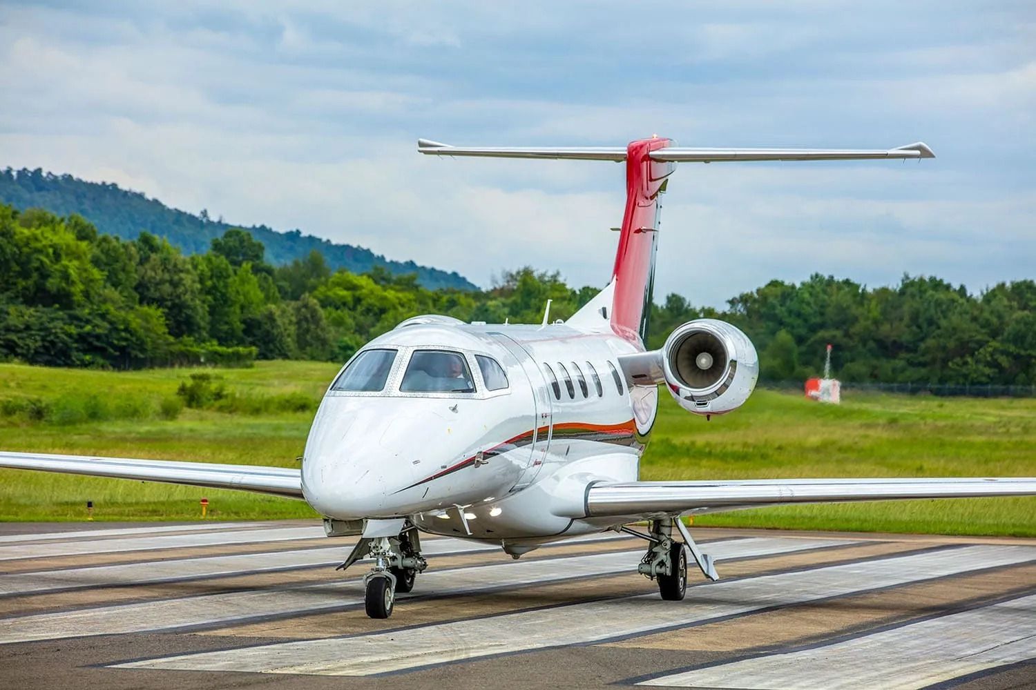  A Nicholas Air Embraer Phenom 300 on an airport apron.