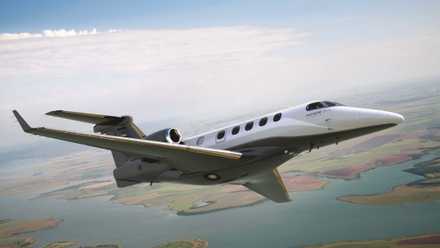 An Embraer Phenom 300EX flying in the sky.