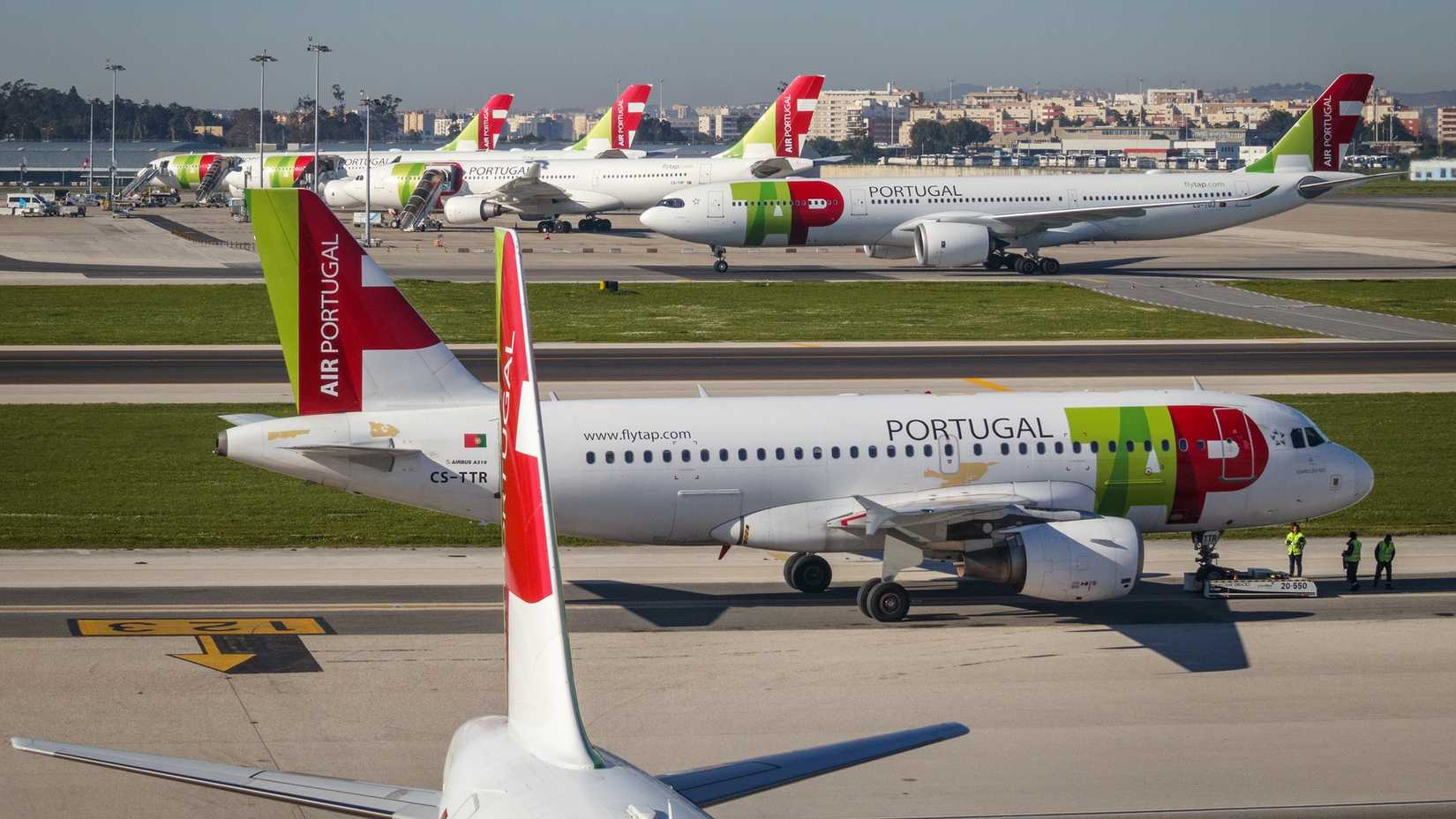 Several TAP Air Portugal aircraft on the apron at Lisbon Airport.