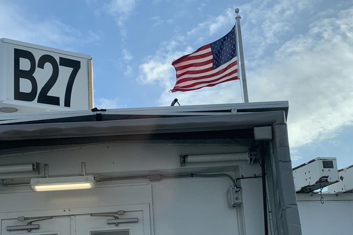Why Do Two Gates At Boston Logan International Airport Have American Flags Fixed To Them?