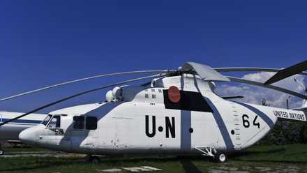 A United Nations Mi-26 sitting in a field.