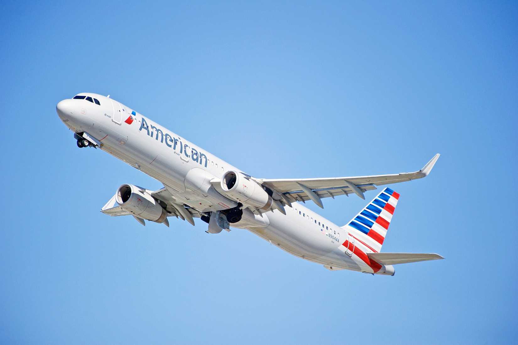 An American Airlines Airbus A321ceo flying in the sky.