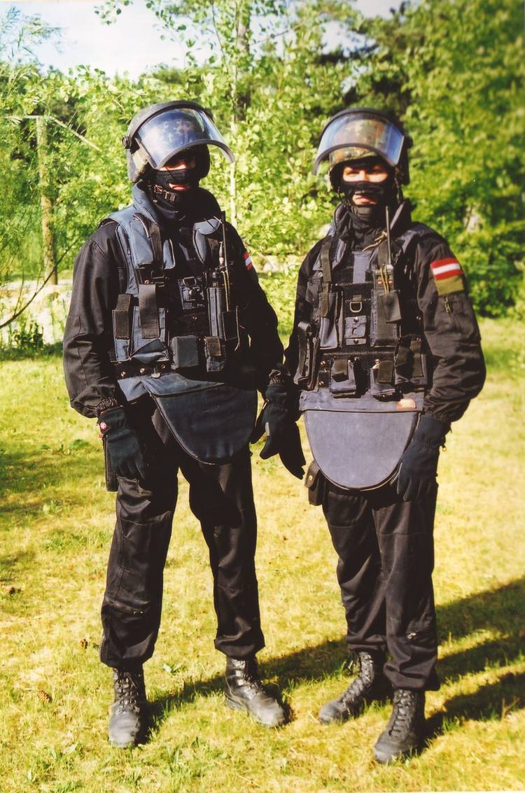 Two people wearing swat team uniforms.