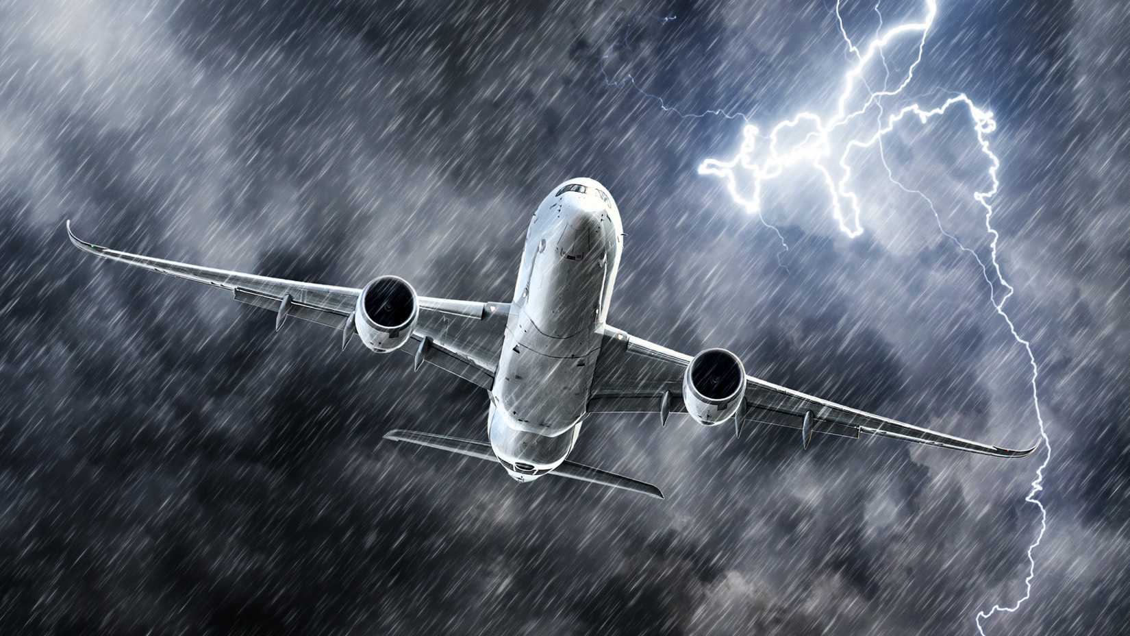 Powerful thunderstorm lightning strike and heavy rain in the sky passenger