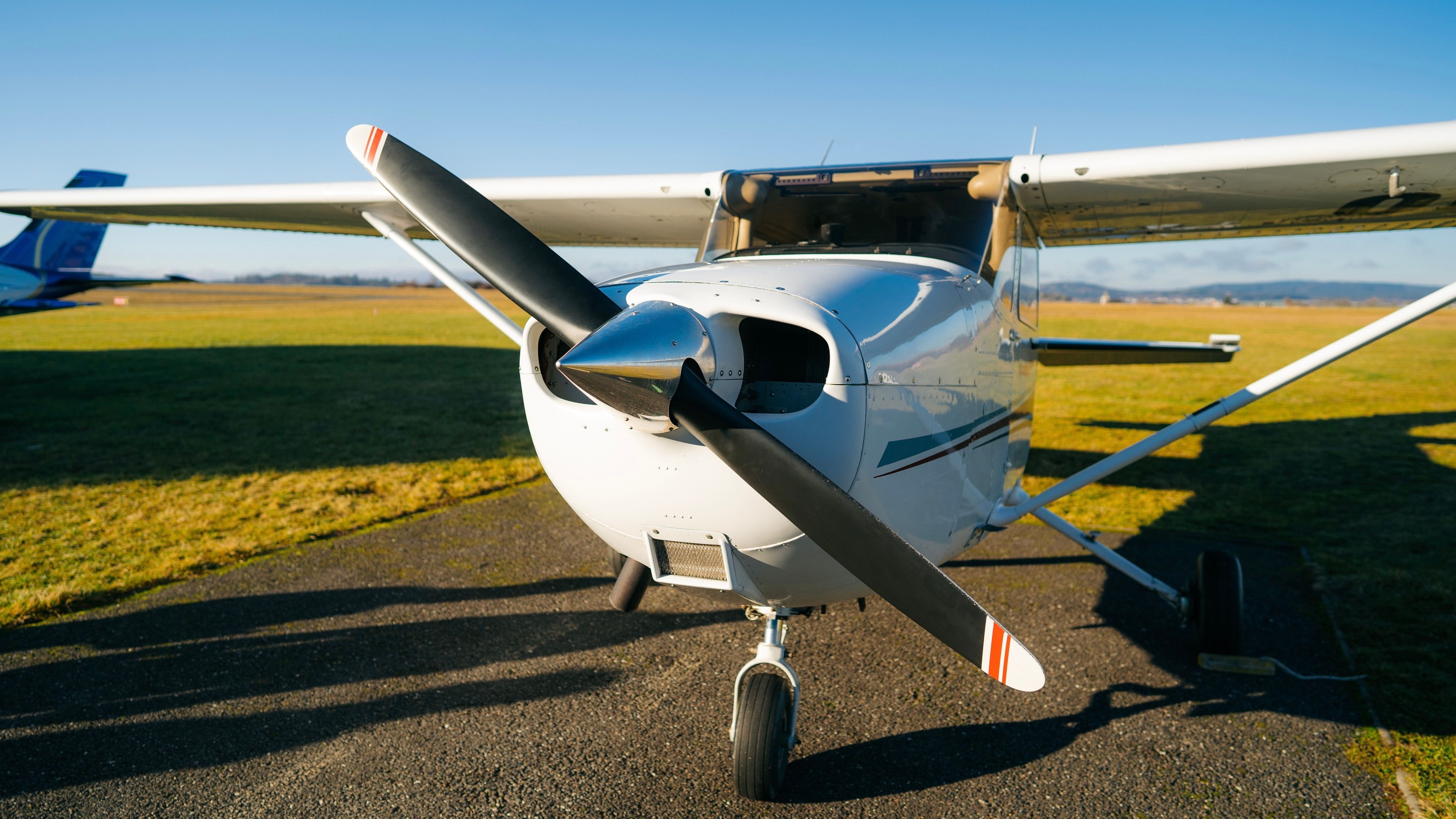 A Cessna 150 parked on the apron of an airport.