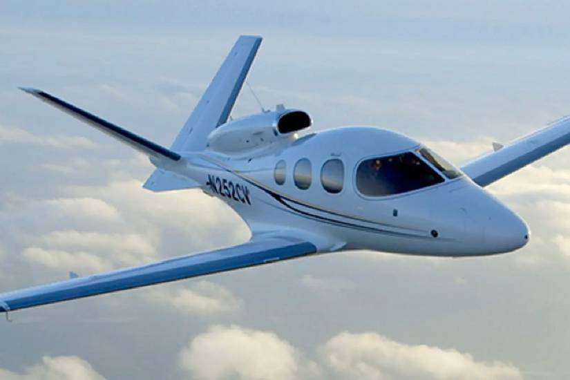 A Cirrus Vision Jet flying in the sky.