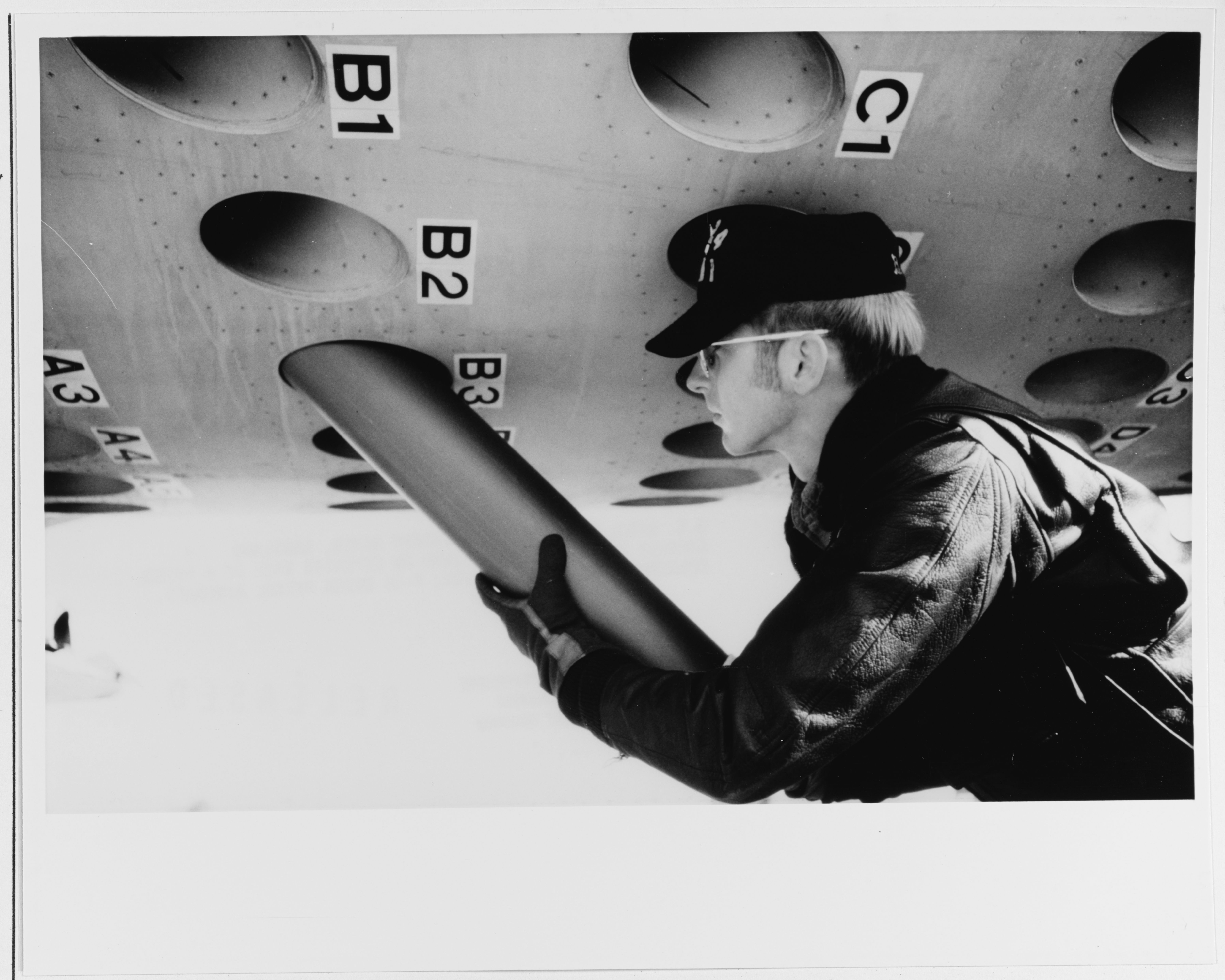 Photo of sonobuoys being loaded into a P-3