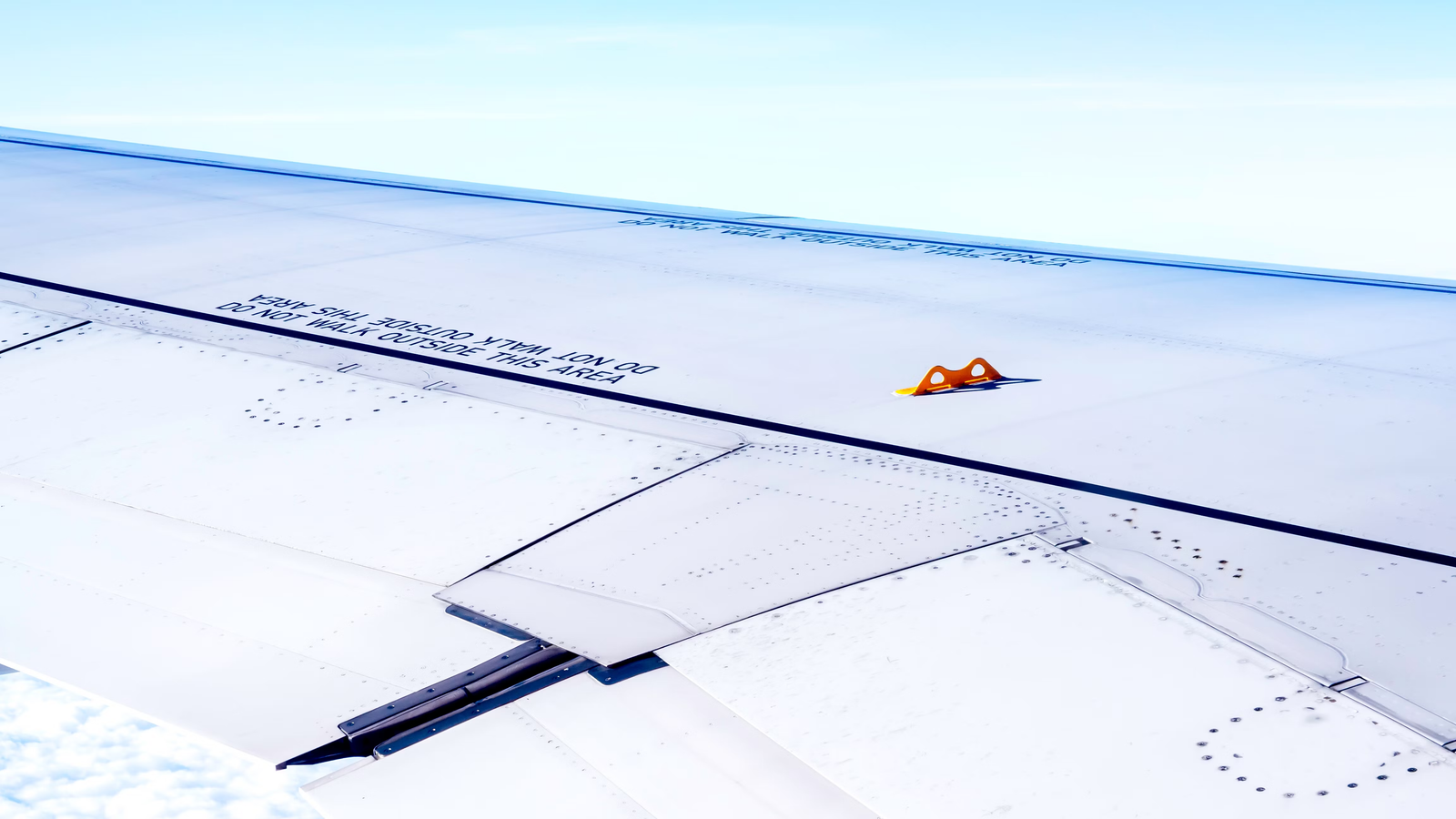 Why Do Airliner Wings Have Little Yellow Hooks?