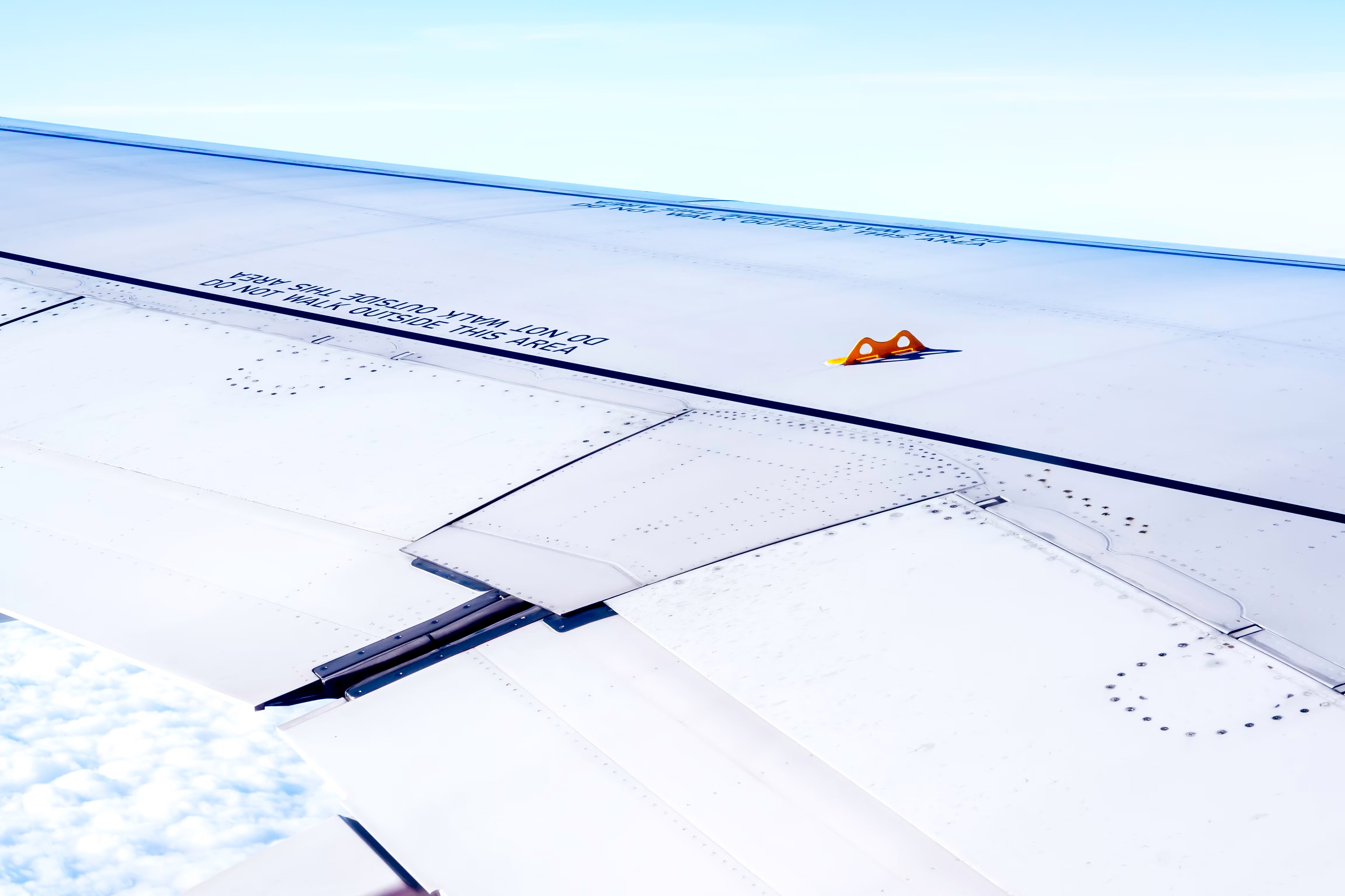 Why Do Airliner Wings Have Little Yellow Hooks?