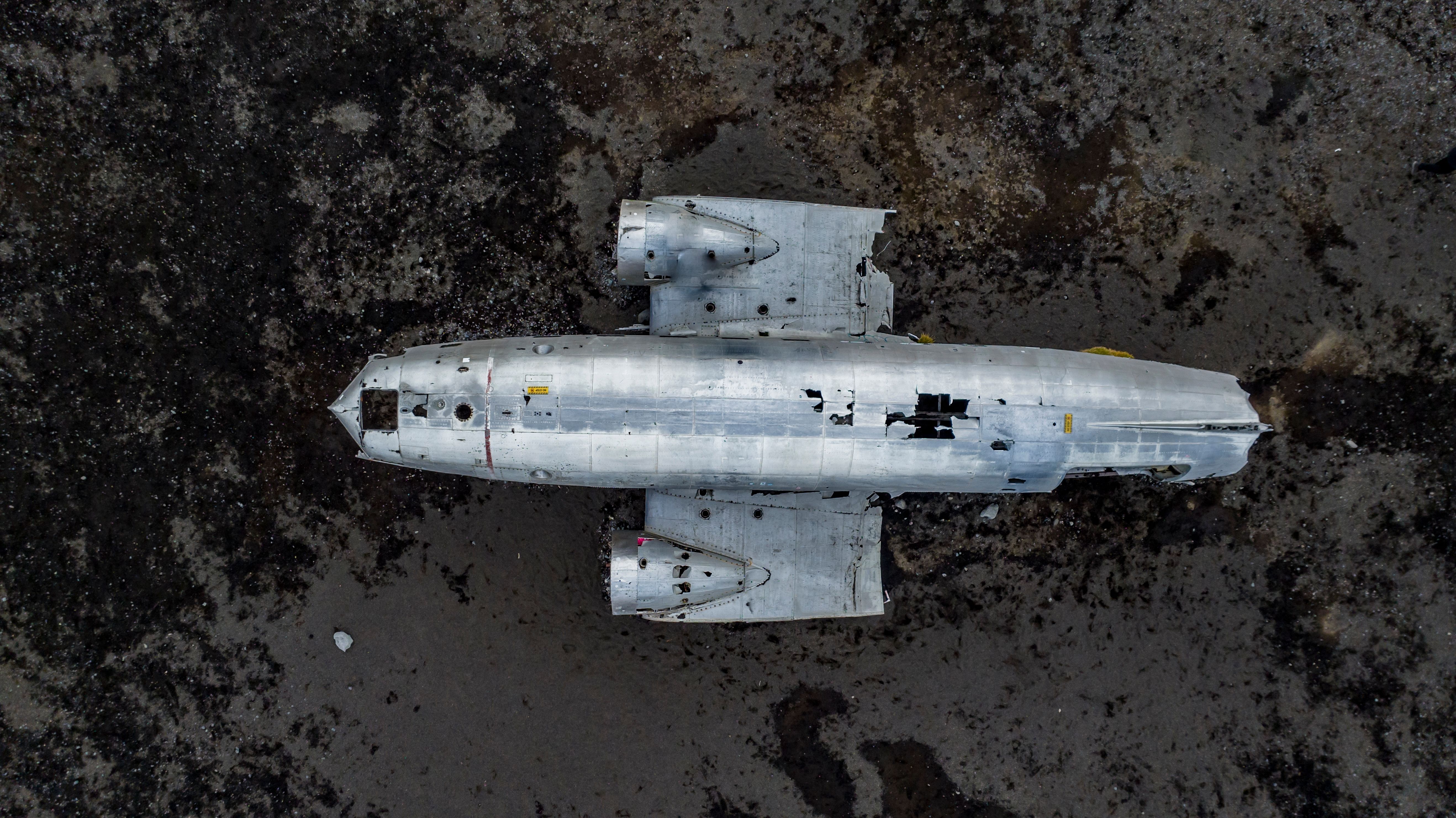 aerial view of damaged Douglas C-117 plane in Iceland, black sand beach