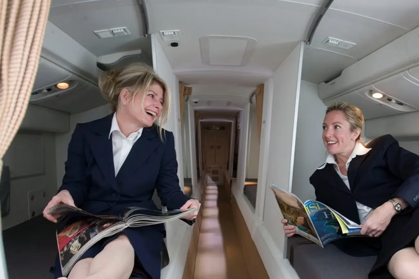 Two Cabin crew members relaxing in the crew rest area 