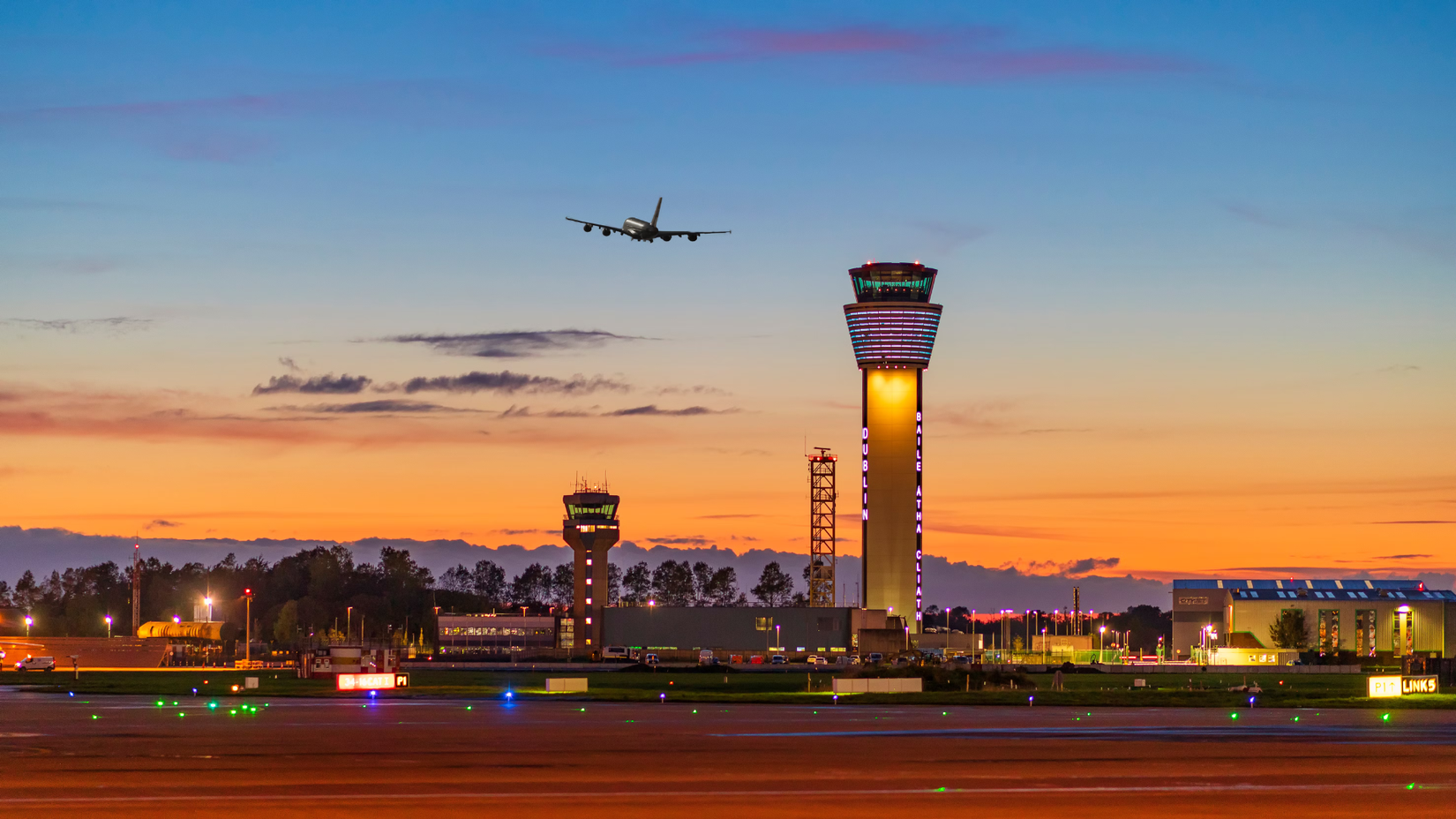 A clear night at Dublin Airport with a quad engine aircraft taking off 