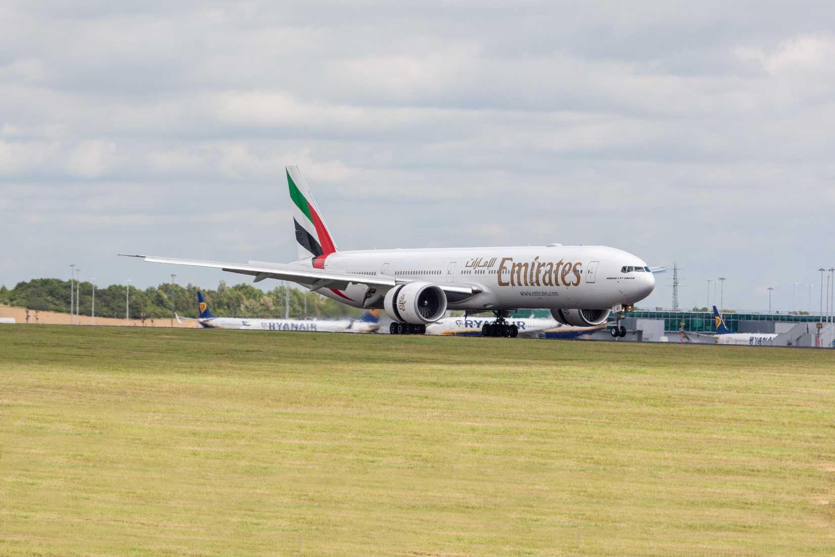 Emirates Boeing 777-300ER taxiing at London Stansted Airport STN shutterstock_2321451251