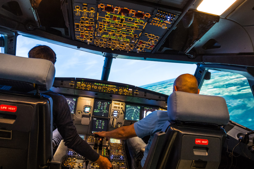 Pilots train in an aircraft flight simulator 