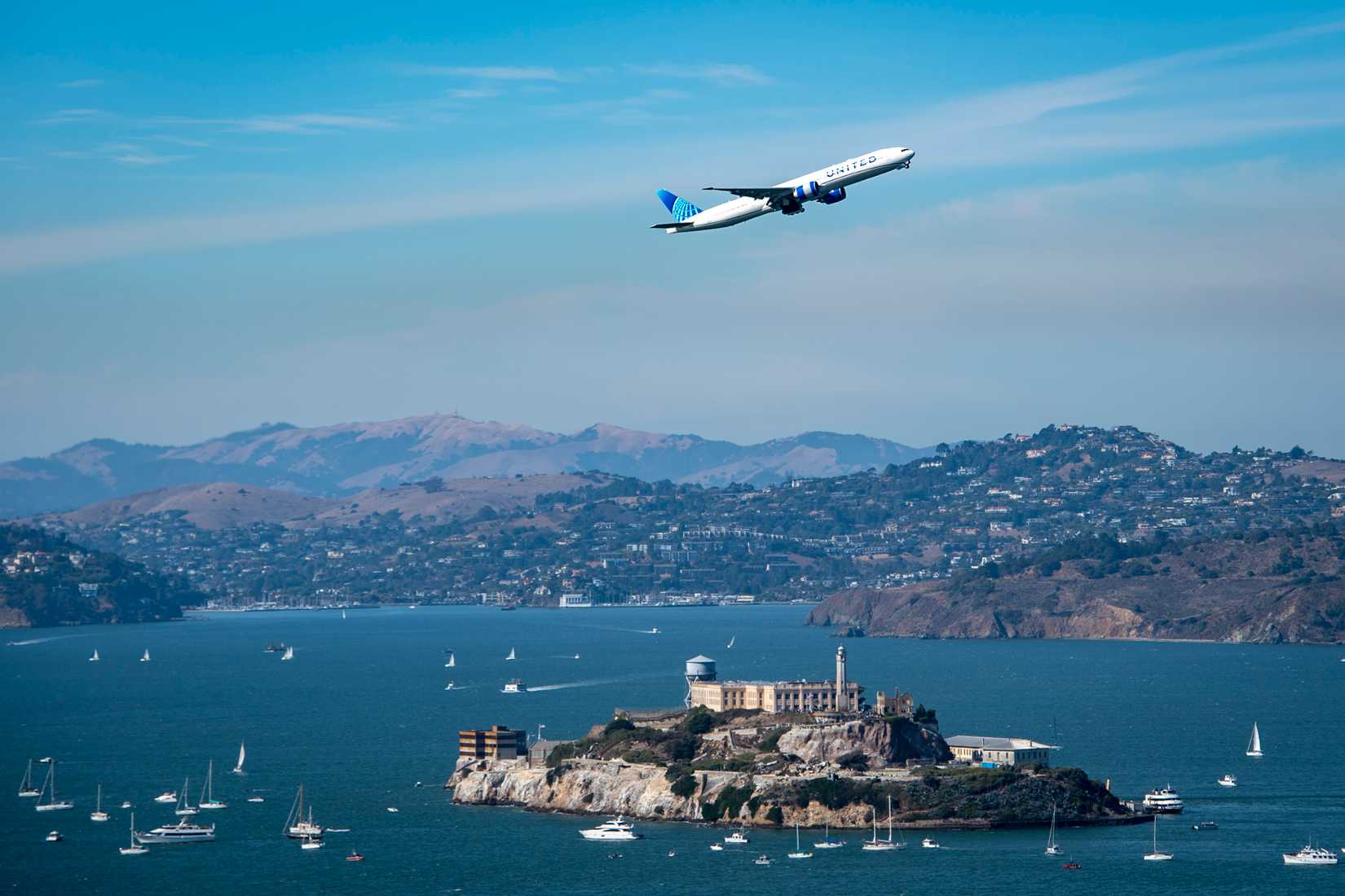 United Airlines Boeing 777-300ER flies over the San Francisco Bay during San Francisco Fleet Week 2024, Oct. 12, 2024.