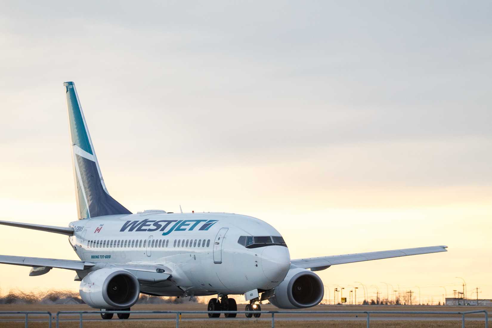 : WestJet Airlines C-GBWS Boeing 737-600 taxiing for takeoff from Calgary International Airport.