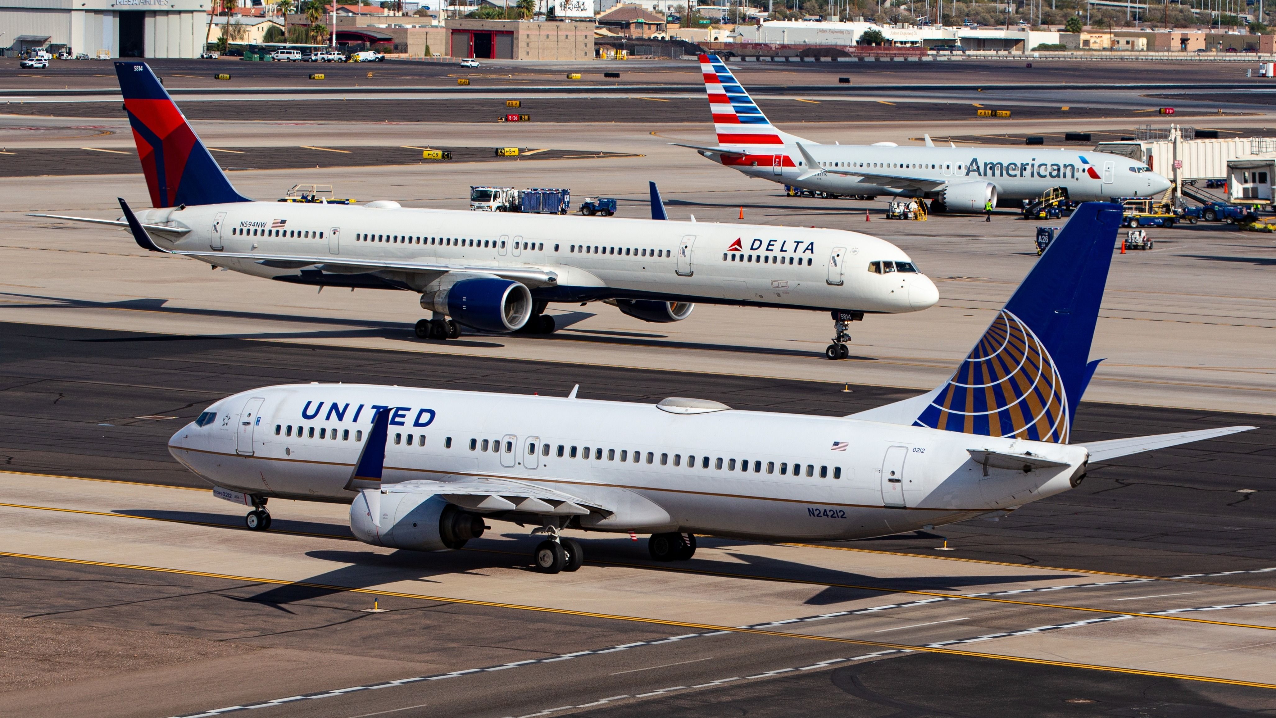 American Airlines, Delta Air Lines, and United Airlines aircraft at PHX shutterstock_2495762415