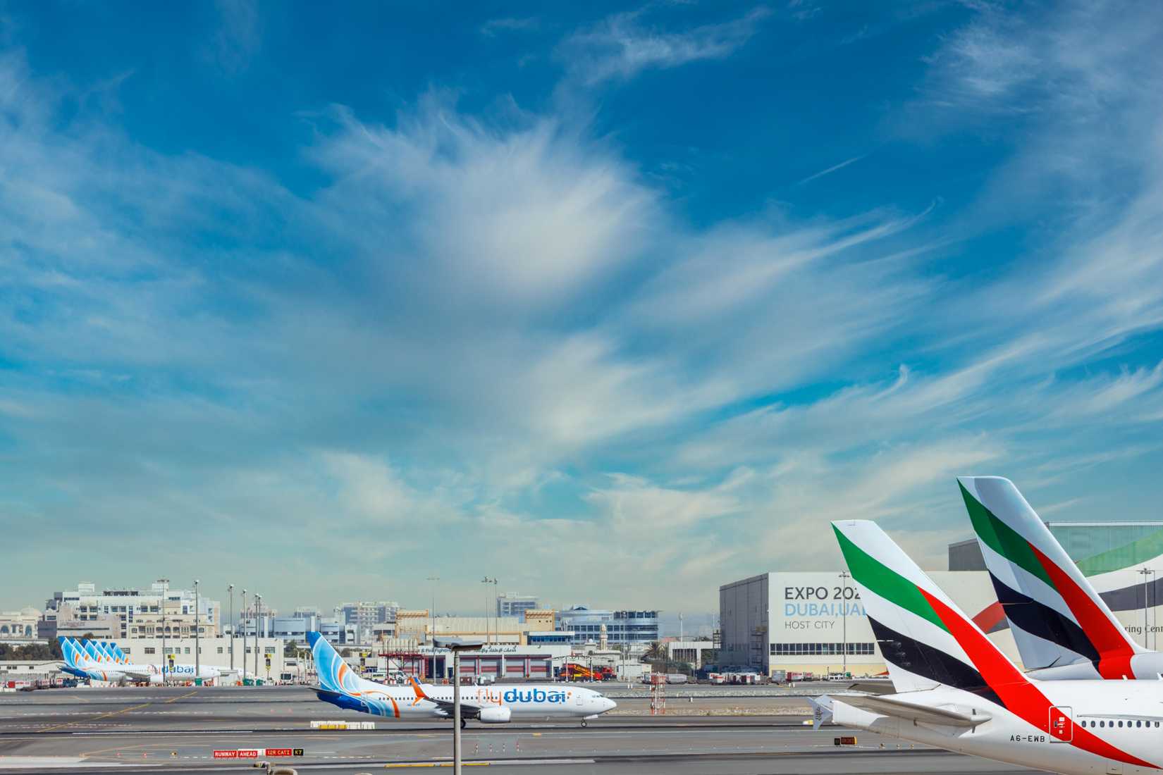 Emirates and flydubai aircraft at Dubai International Airport DXB shutterstock_1941186091