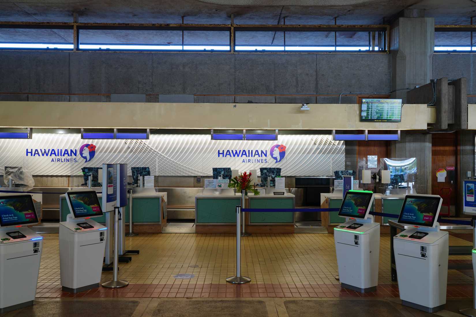 Hawaiian Airlines check-in kioks at Maui Kahului Airport OGG shutterstock_2008955363