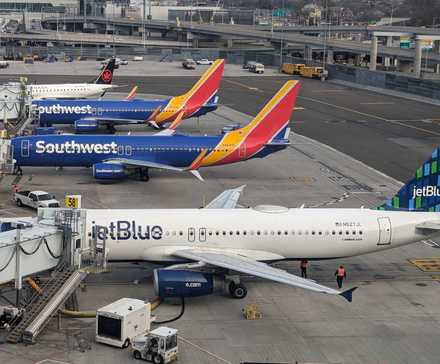 Air Canada, JetBlue, and Southwest Airlines aircraft at LGA shutterstock_2473321107