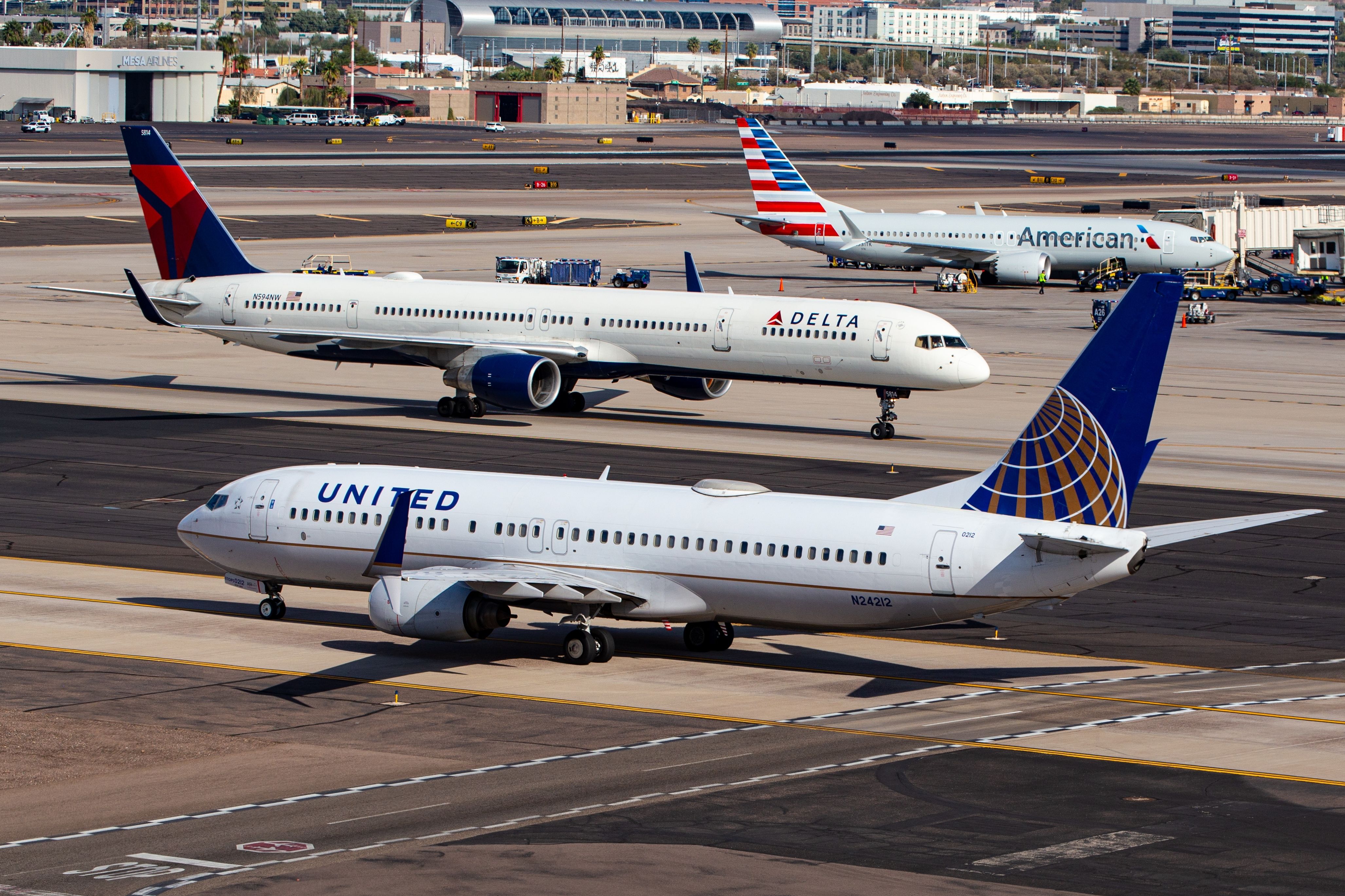 American Airlines, Delta Air Lines, and United Airlines aircraft at Phoenix Sky Harbor International Airport PHX shutterstock_2495762415