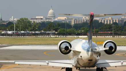 Delta Connection regional jet in front of the Capitol at Ronald Reagan Washington National Airport DCA shutterstock_3576037