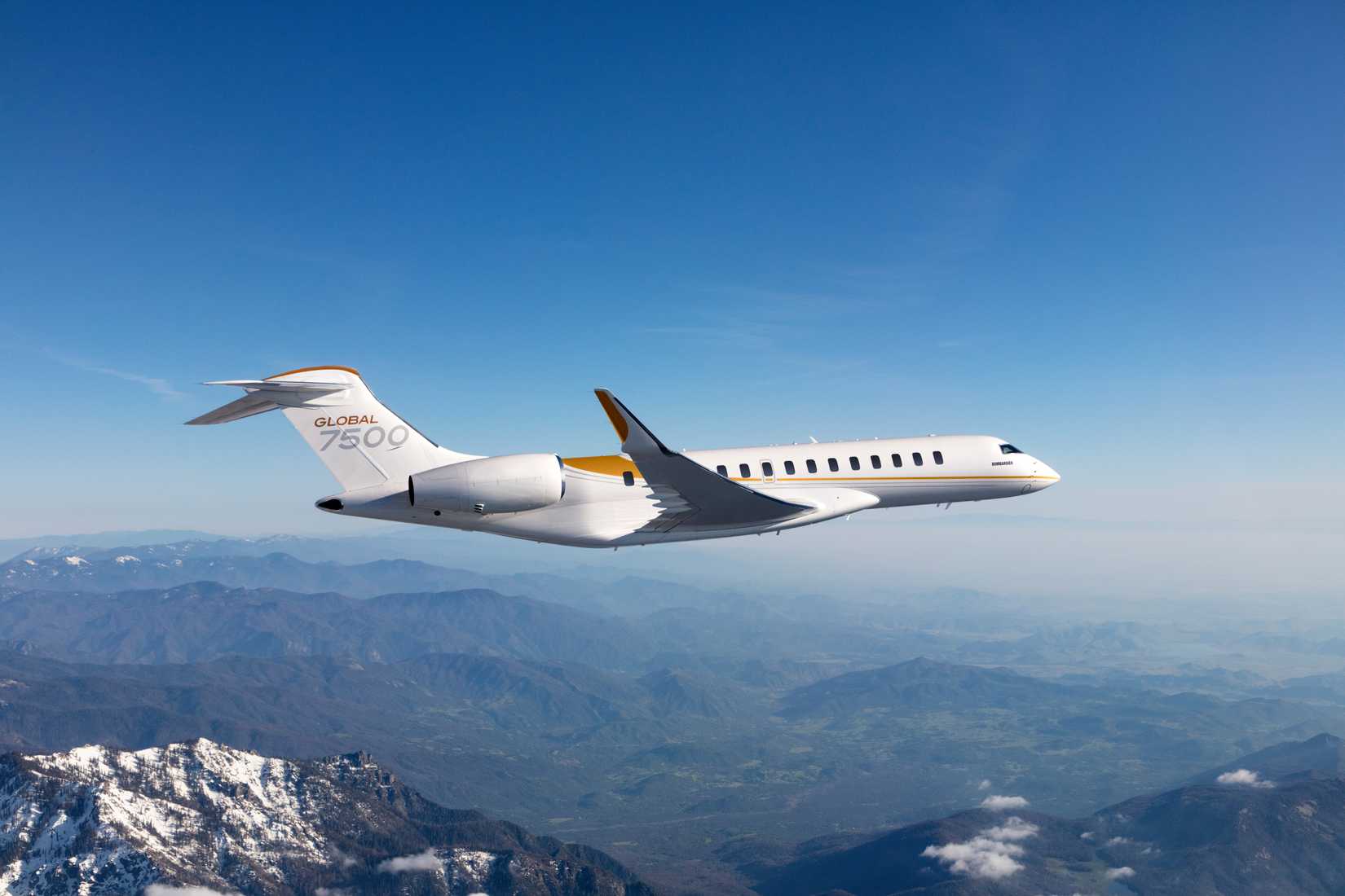 Global 7500 flying over small mountains.