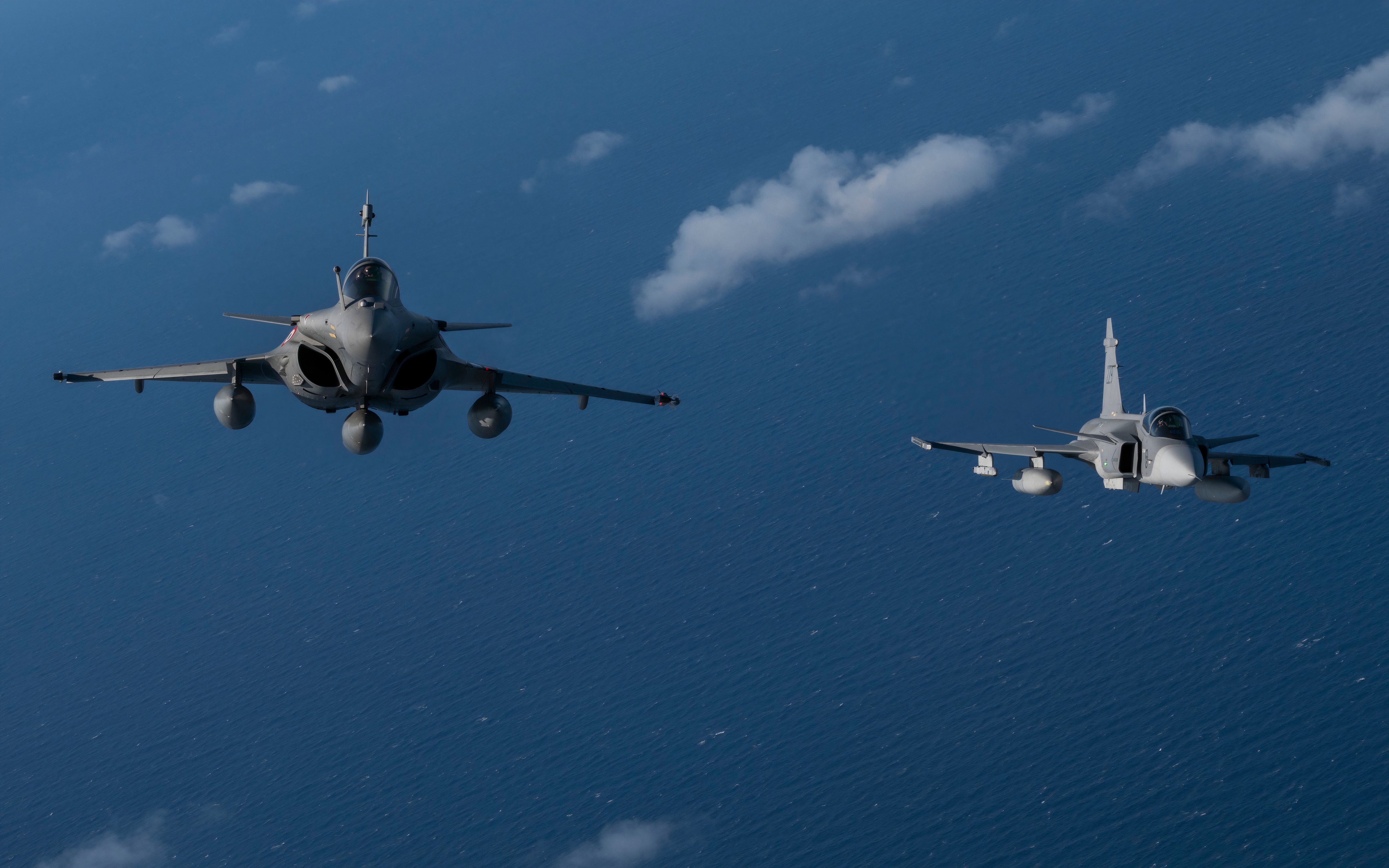 8682201 - An Italian Air Force Eurofighter Typhoon, left, participating in NATO exercise Ramstein Flag 24, flies in formation with a Swedish Air Force JAS 39 Gripen over the west coast of Greece, Oct. 4, 2024. Over 130 fighter and enabler aircraft from Greece, Canada, France, Hungary, Italy, Poland, Portugal, Romania, Spain, Sweden, United Kingdom and United States are training side by side to improve tactics and foster more robust integration, demonstrating NATO’s resolve, commitment and abilit