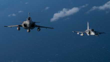 8682201 - An Italian Air Force Eurofighter Typhoon, left, participating in NATO exercise Ramstein Flag 24, flies in formation with a Swedish Air Force JAS 39 Gripen over the west coast of Greece, Oct. 4, 2024. Over 130 fighter and enabler aircraft from Greece, Canada, France, Hungary, Italy, Poland, Portugal, Romania, Spain, Sweden, United Kingdom and United States are training side by side to improve tactics and foster more robust integration, demonstrating NATO’s resolve, commitment and abilit