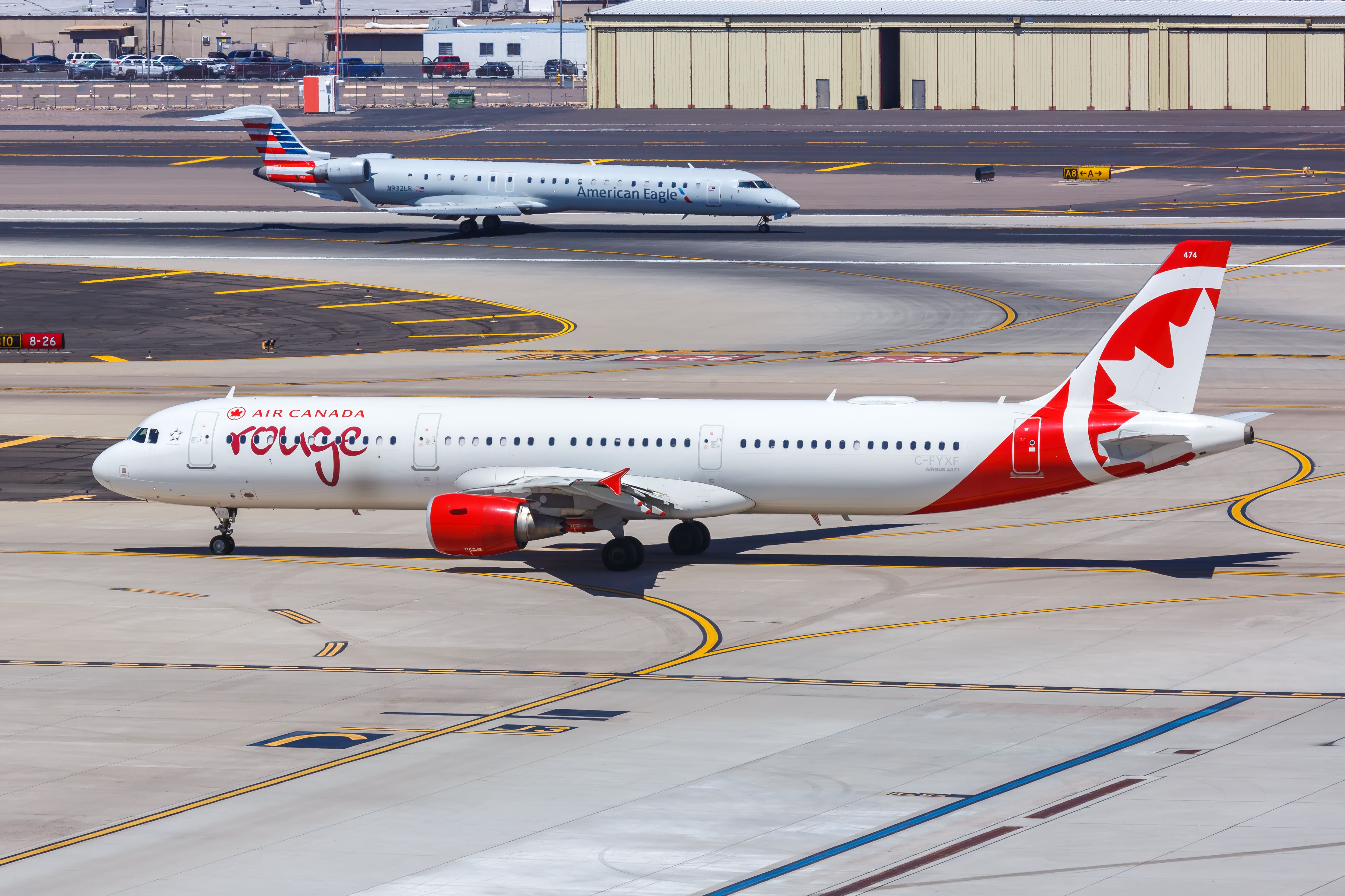 Air Canada Rouge Airbus A321 taxiing at Phoenix Sky Harbor International Airport PHX shutterstock_1864652659
