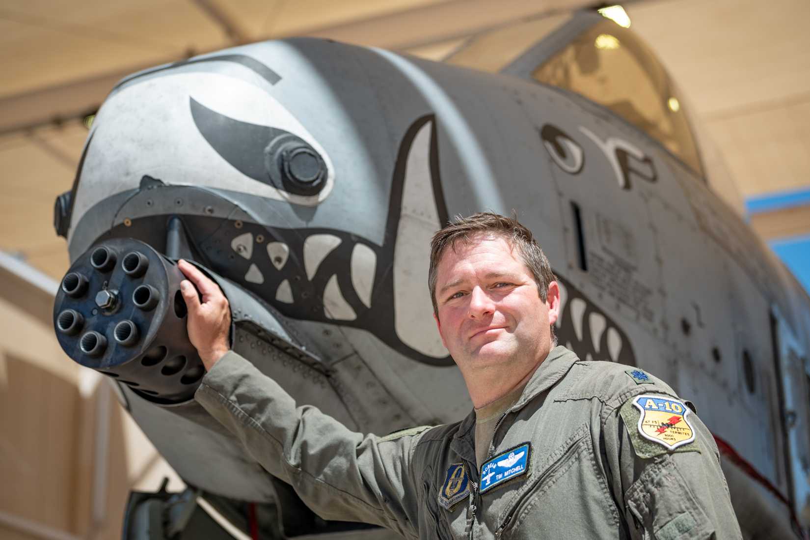 Lt. Col. Timothy “Scream” Mitchell, an A-10 instructor pilot and flight commander with the 47th Fighter Squadron, places his hand on the iconic nose of an A-10C Thunderbolt II