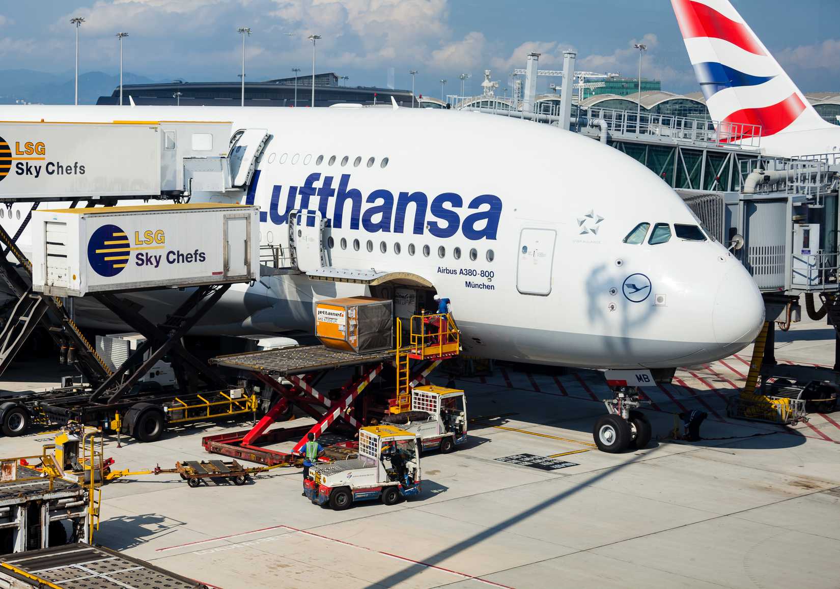 shutterstock_1097809040 - Chek Lap Kok, Hong Kong - May 17 2018: A Lufthansa A380 aircraft is being catered and cleaned as passengers disembark while cargo is unloaded after arriving at Hong Kong International Airport .