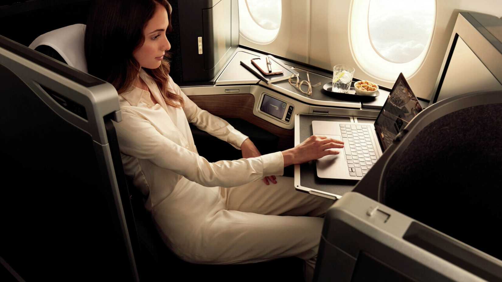 A passenger sitting in the British Airways Club Suite