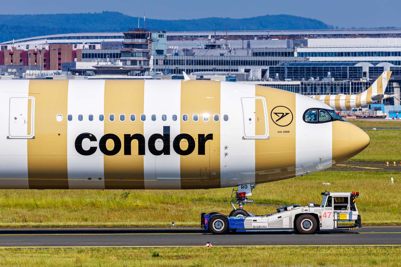 Condor Airbus A330-900 being tugged at Frankfurt Airport FRA shutterstock_2469416315