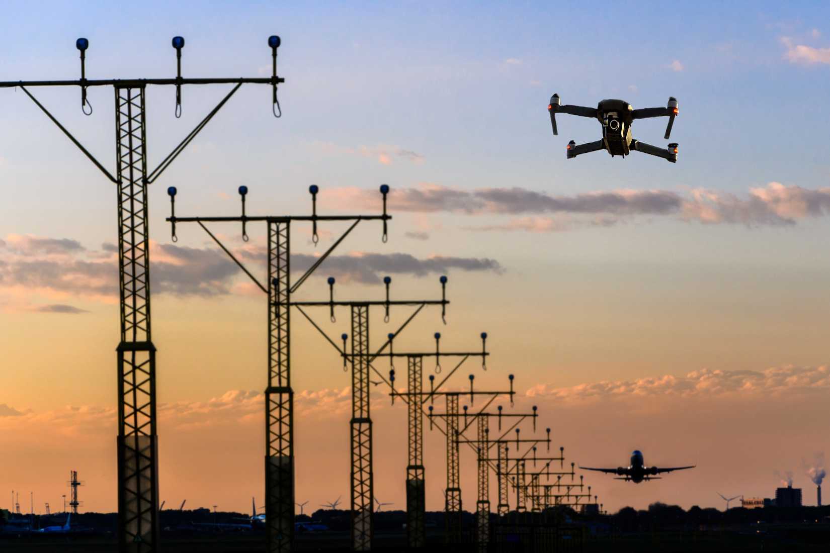 Rendering of a drone flying near a runway shutterstock_1263466825